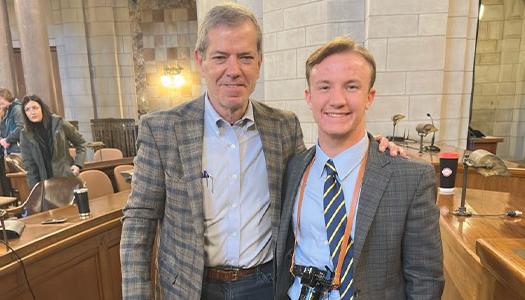 a student poses for a photo with nebraska governer jim pillen